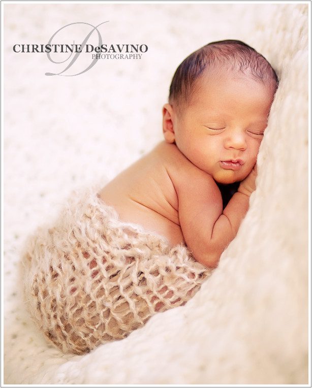 soft and beautiful baby cuddling on blanket