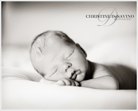 Black and white image of a newborn boy sleeping.