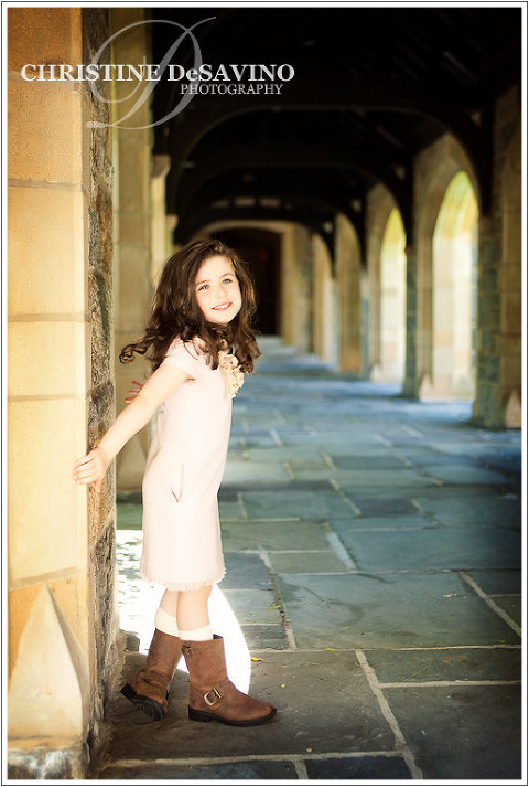 Beautiful girl in church courtyard with arches.