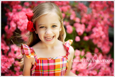 Girl laughing with pink pansies in background
