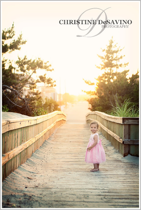 Baby girl on the boardwalk along the beach during golden sunset on LBI