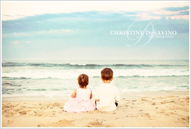 Boy and girl sit facing the ocean on Long Beach Island Boy and girl sit facing the ocean on Long Beach Island