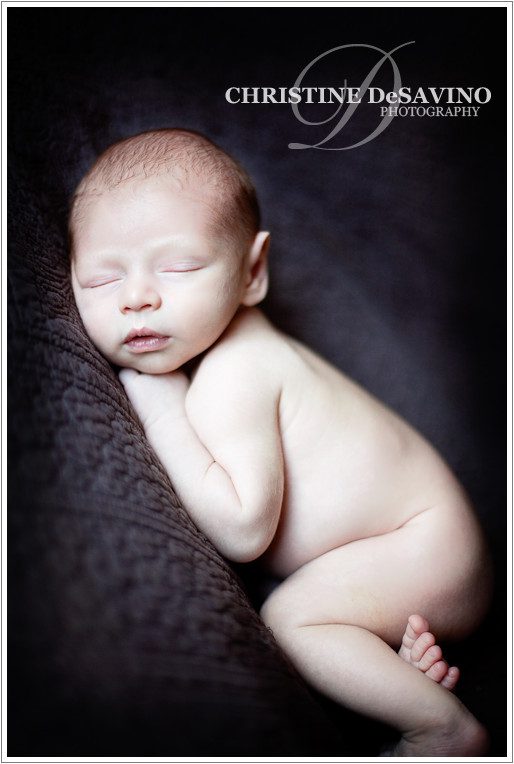 Precious newborn boy sleeping on blanket