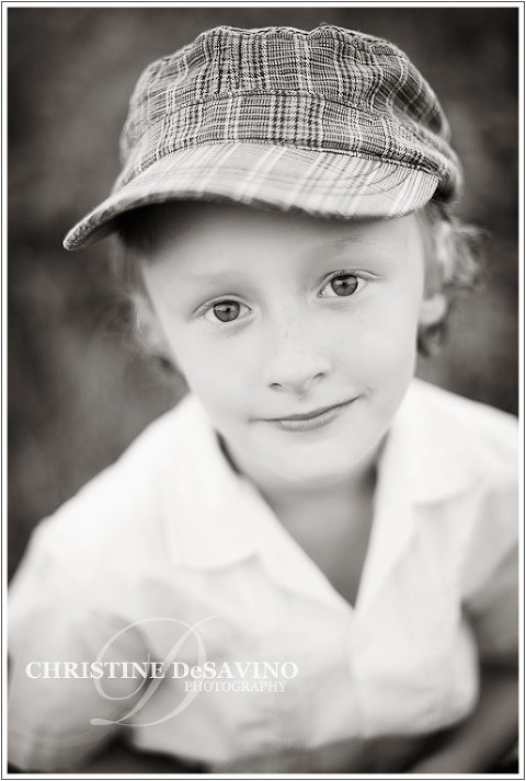black and white image of boy with hat