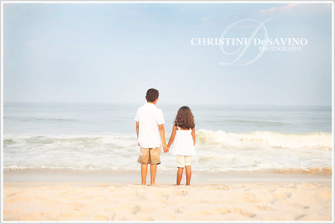 Brother and sister hold hands by ocean - NJ Beach Photographer - LBI, New Jersey