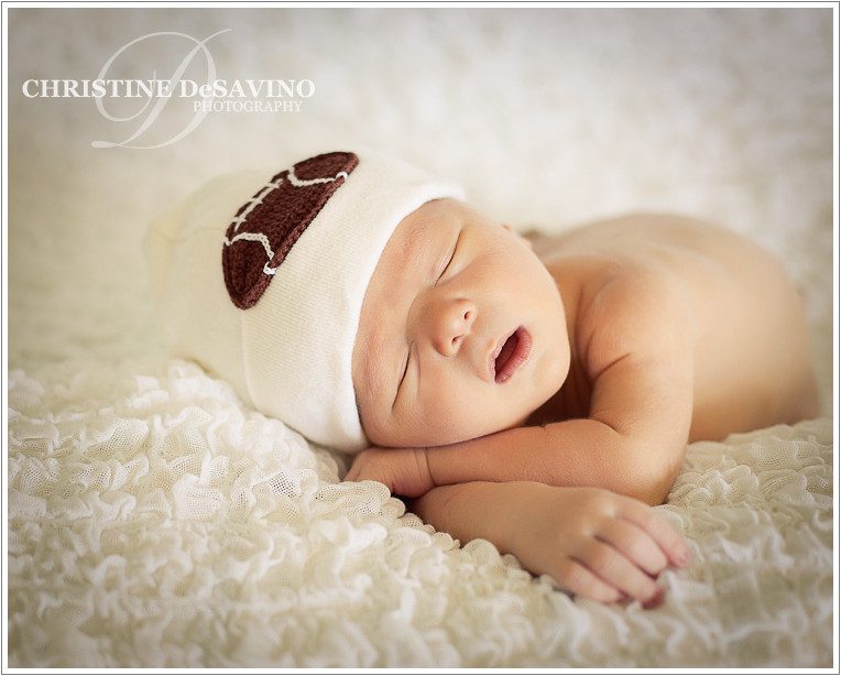 Newborn in a football hat - NJ Newborn Photographer