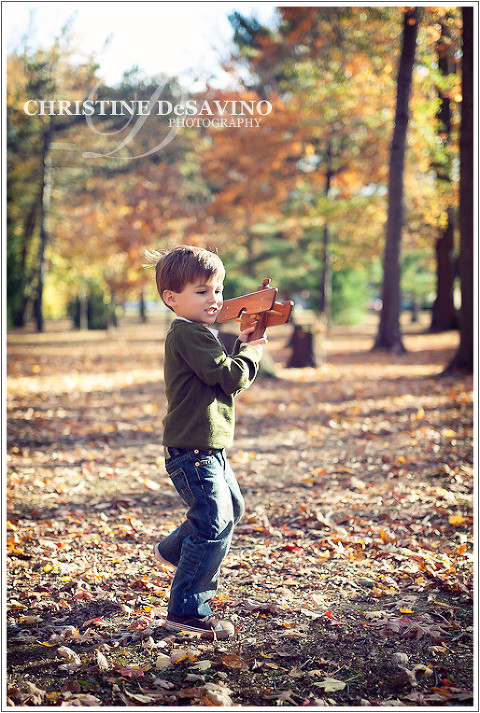 Boy flying wooden plane - NJ Children's Photographer