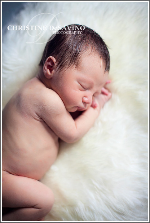 Newborn sleeps on white fur blanket - NJ Newborn Photographer
