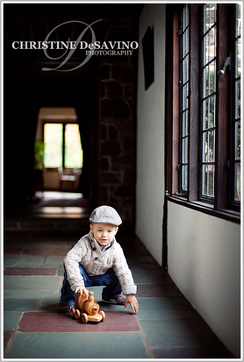 Boy plays with train by window - NJ Child Photographer