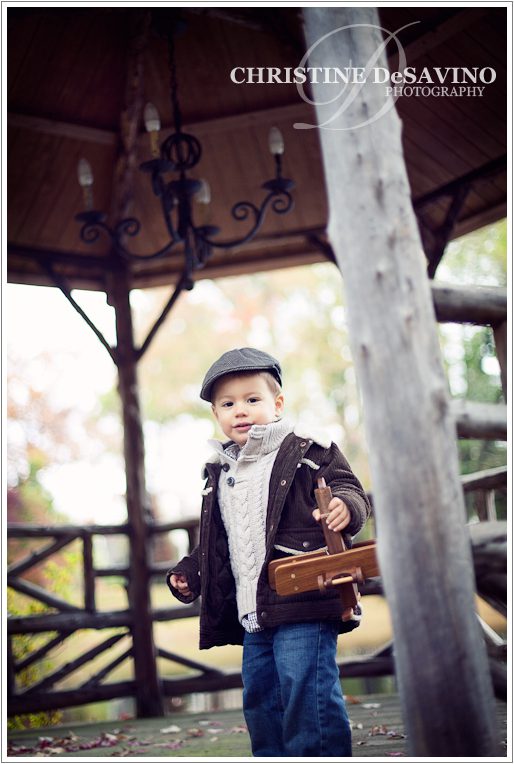 Boy on gazebo with wooden airplane - NJ Child Photographer