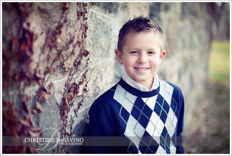 Handsome boy leans against stone wall - NJ Child Photographer