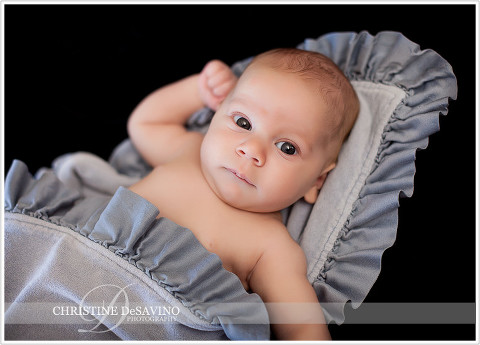 Bright eyed baby on blue blanket - NY Baby Photographer