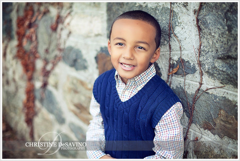 Handsome boy leans against stone wall - NJ Child Photographer