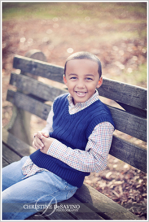 Boy smiling on a bench - NJ Children's Photographer