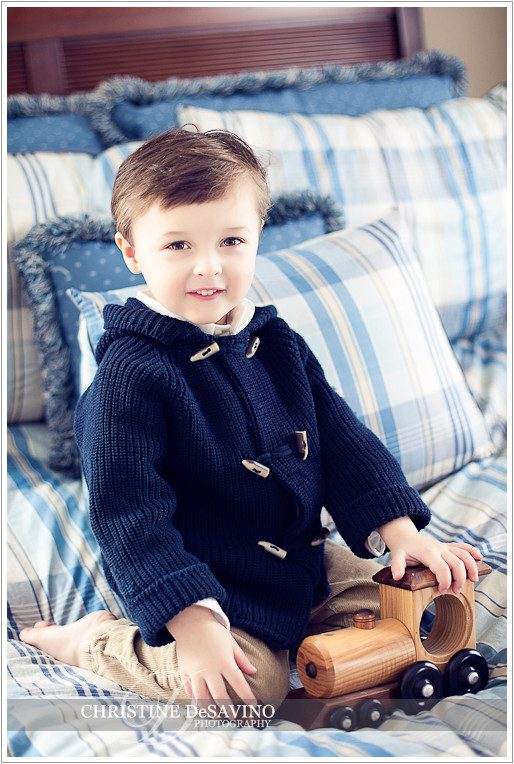 Boy on bed with train - NJ Child Photographer