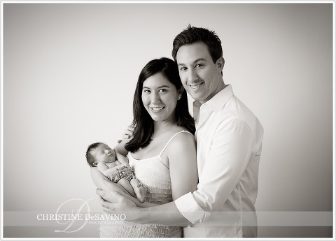 Mother and father hold baby girl -  NJ Newborn Photographer