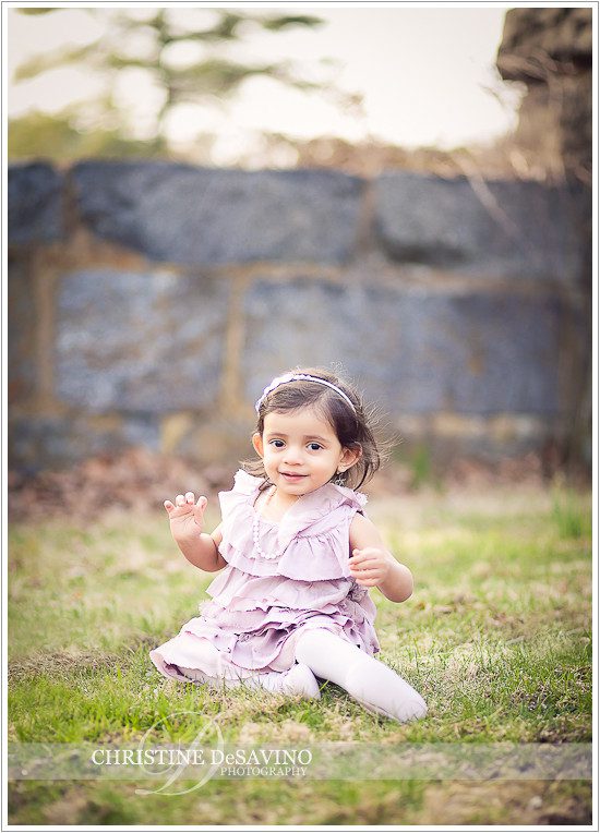 Beautiful girl sitting near stone wall - NY Child Photographer
