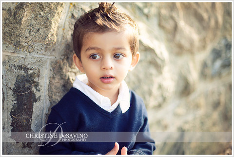 Sunlit boy by stone wall - NY Child Photographer