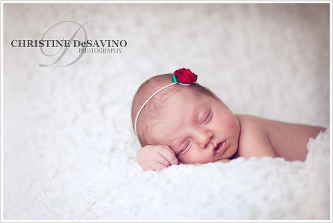 Beautiful newborn girl sleeping with red flower headband - NJ Newborn Photographer