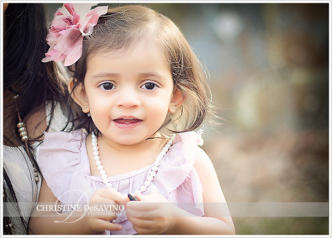 Adorable girl smiling with lavender bow - NY Child Photographer