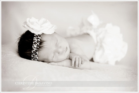 Beautiful newborn wears flower head with leopard skin band - NJ Baby Photographer