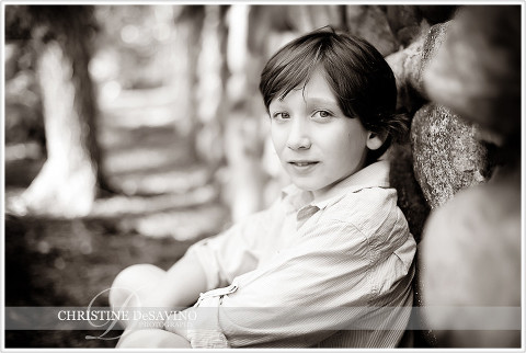 Boy sits against stone wall - NJ Child Photographer
