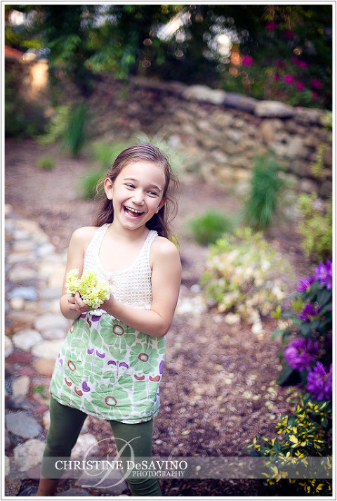 Girl with flower laughing - NJ Children's Photographer