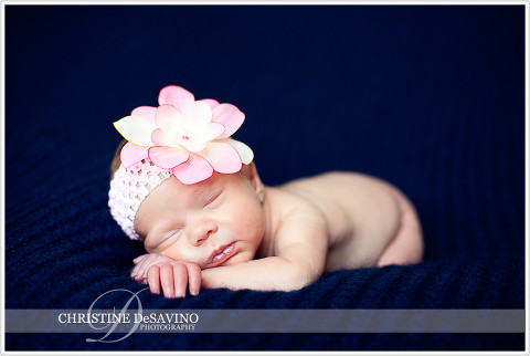 Newborn girl with pink flower - NJ Newborn Photographer