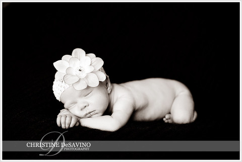 Black and white image of newborn girl with flower headband - NJ Newborn Photographer