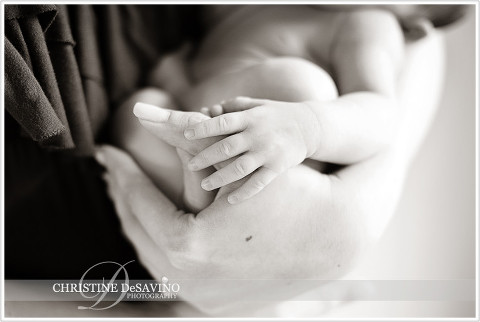 Newborn girl with hand on mother's - NJ Newborn Photographer