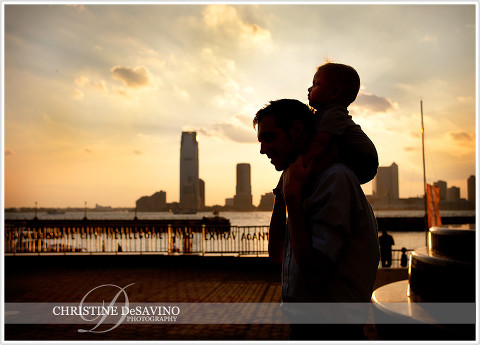 Silhouette of father and son along Hudson River - NYC Family Photographer