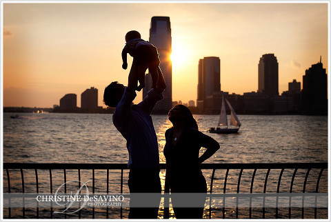 Silhouette of family along Hudson River - NYC Family Photographer