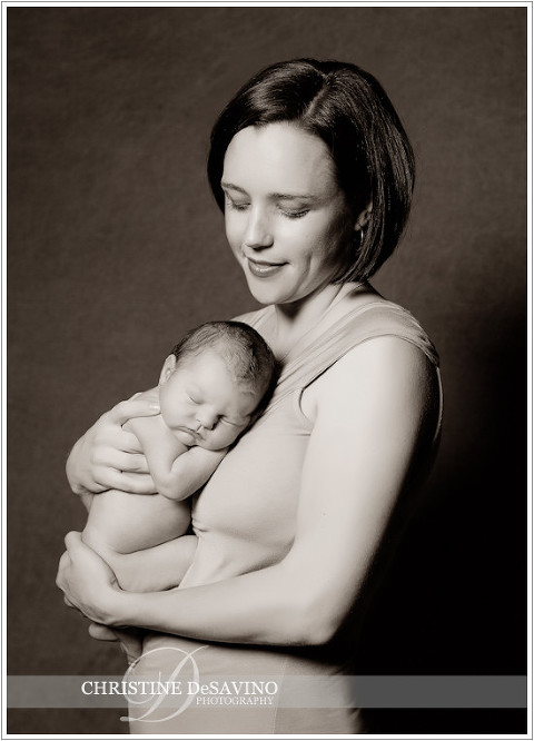 Beautiful mother holding newborn baby girl - NJ Newborn Photographer