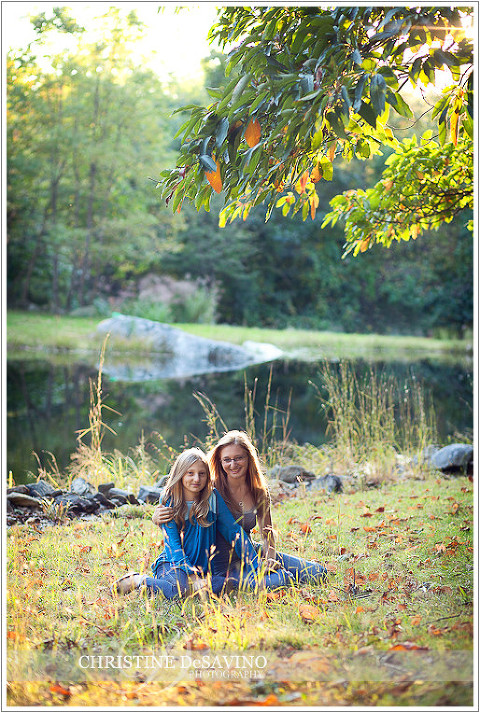 Sisters sunlit by pond - NY Portrait Photographer